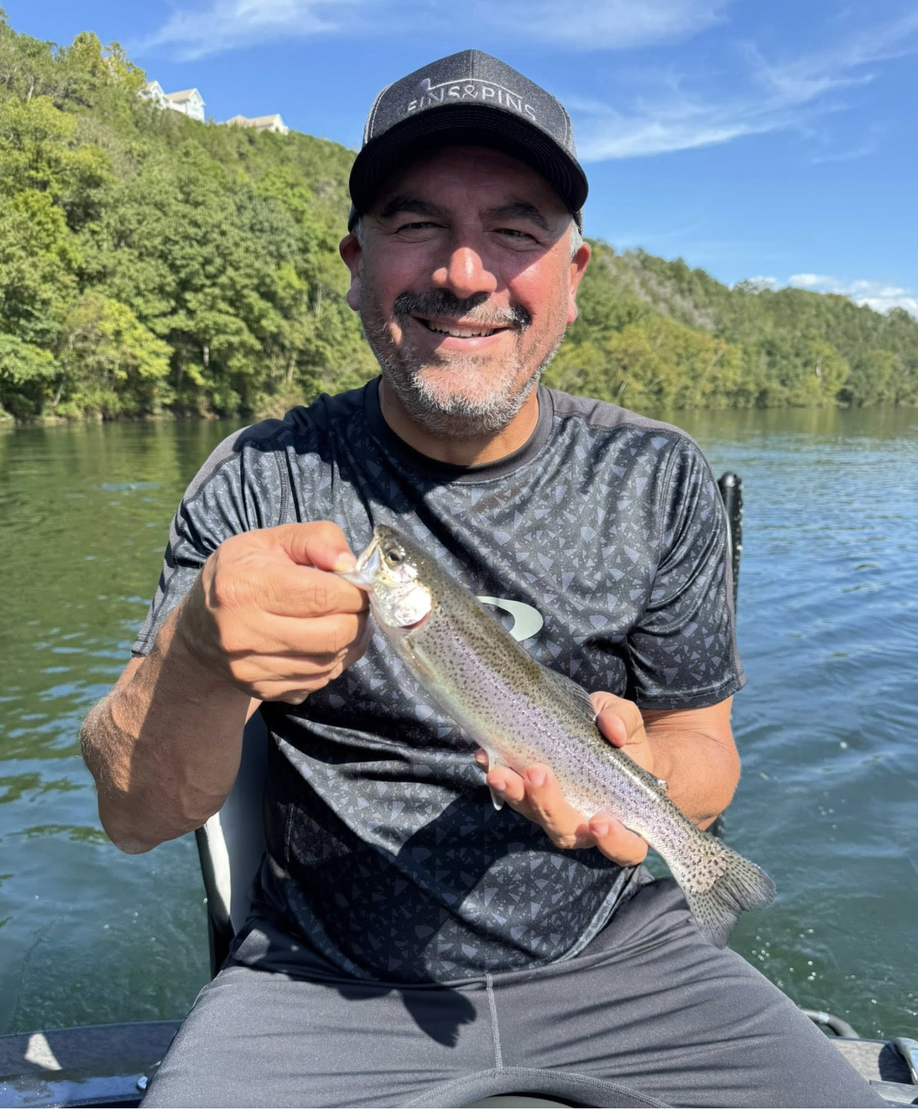 Angler with a rainbow trout on Lake Taneycomo