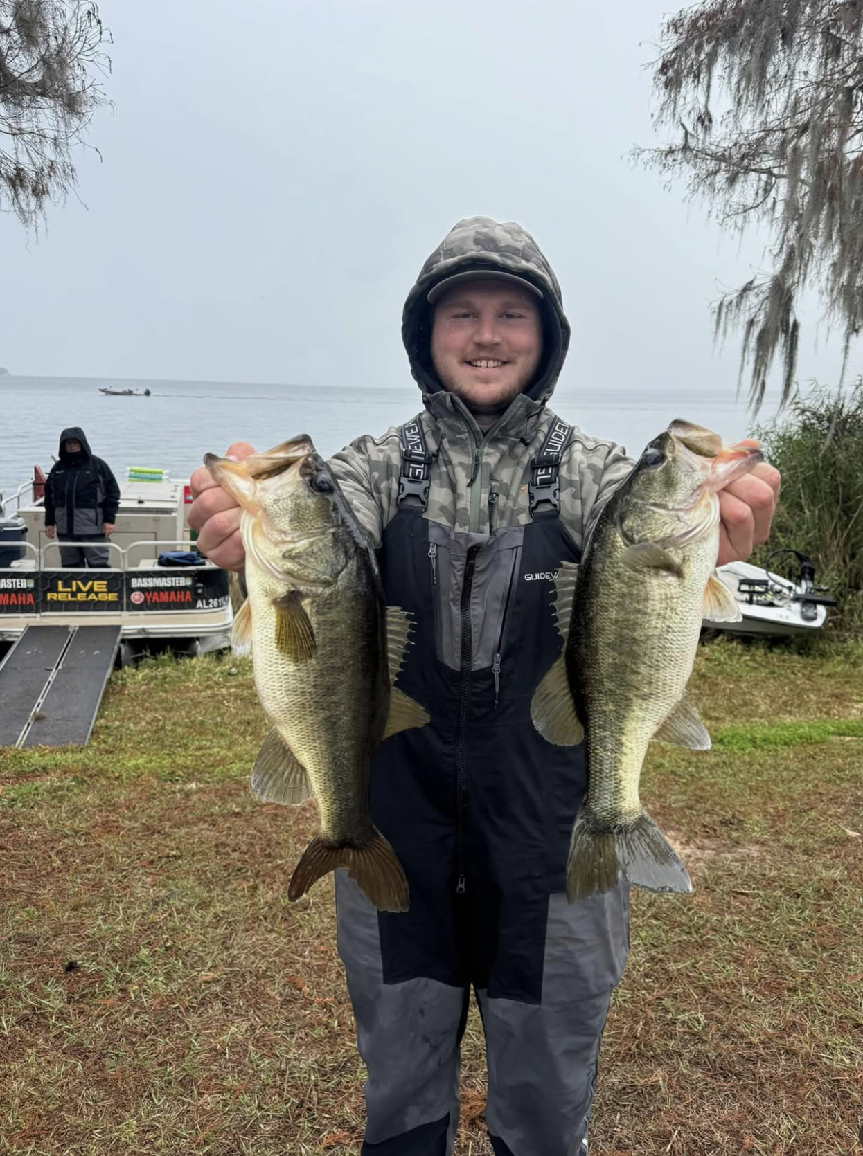 Angler holding a double largemouth bass catch